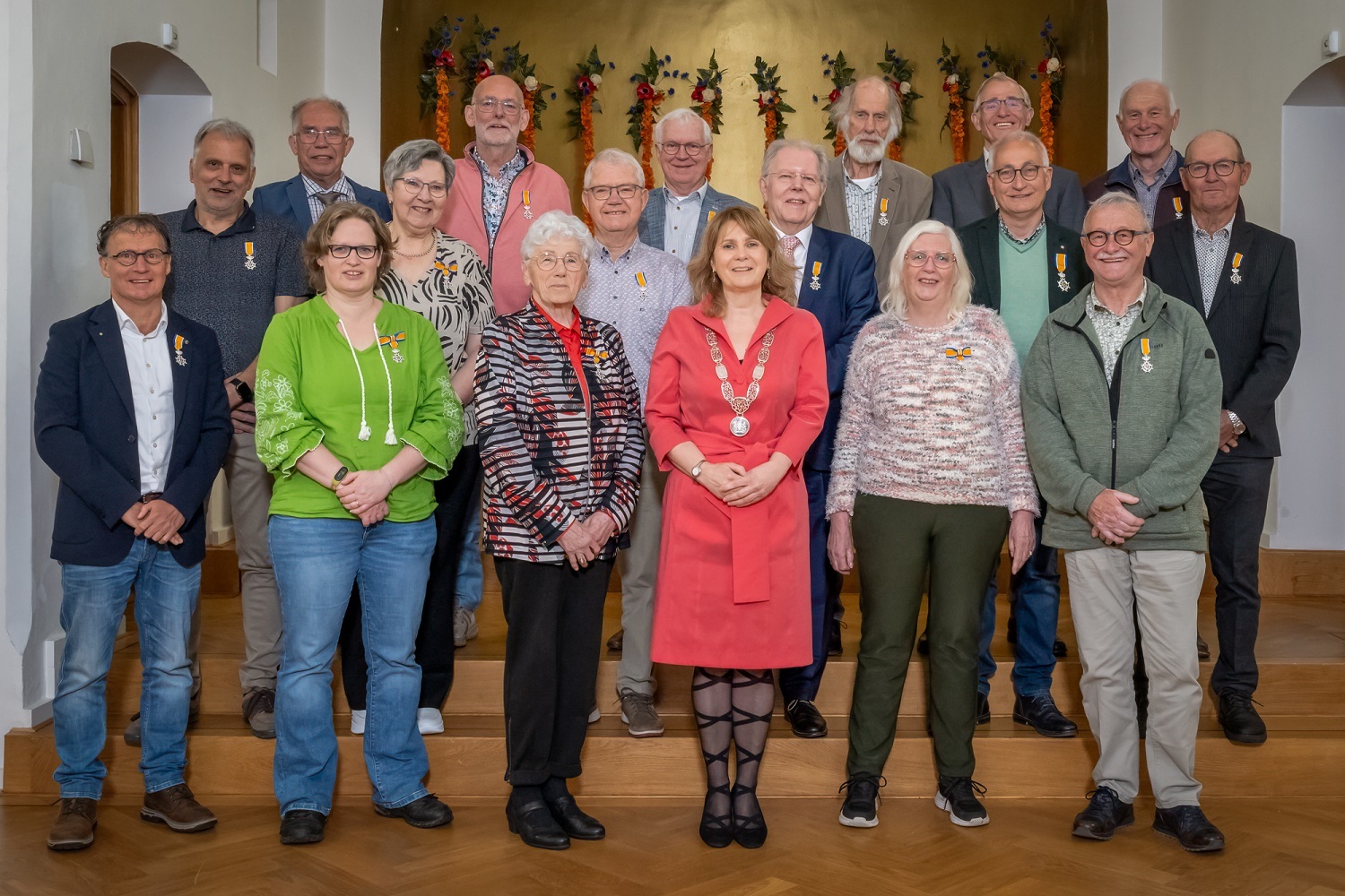 Foto Lintjesdag waarop de burgemeester staat met de mensen staan die een lintje hebben gekregen